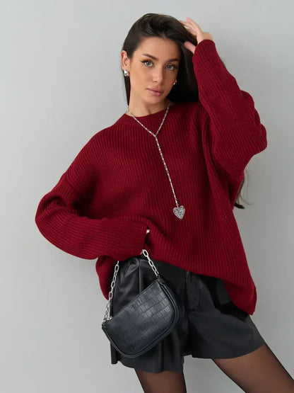 Model wearing Maribel Sweater by Lauven in oversized burgundy knit with stylish black shorts.