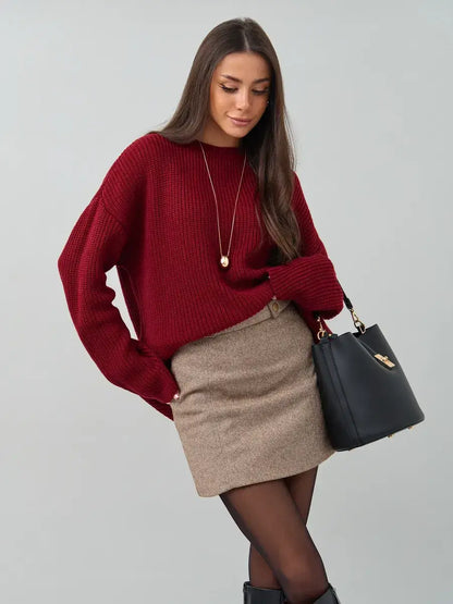 Maribel Sweater by Lauven in oversized burgundy knit, styled with a skirt and accessories for a chic look.