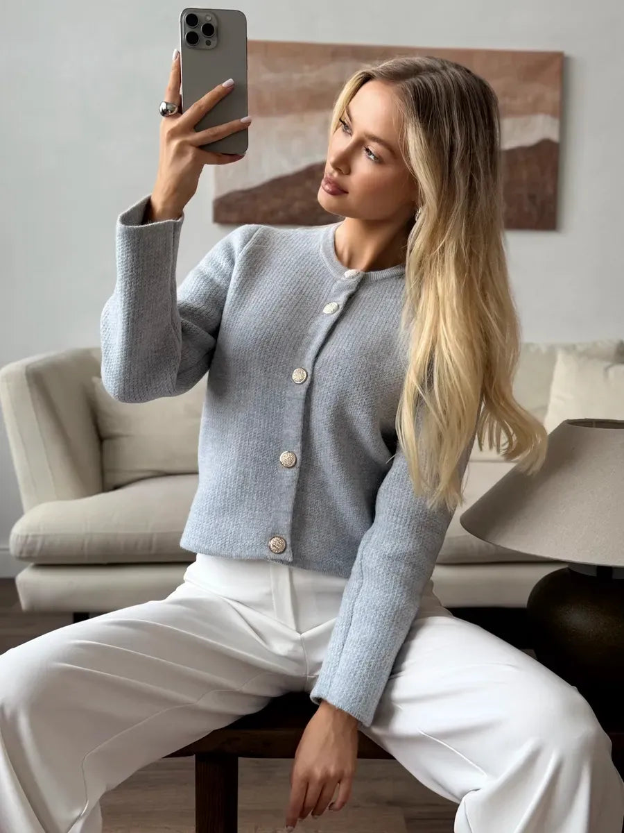 Marin Cardigan by Lauven in light gray, showcasing cropped knitwear with button closure on a model.