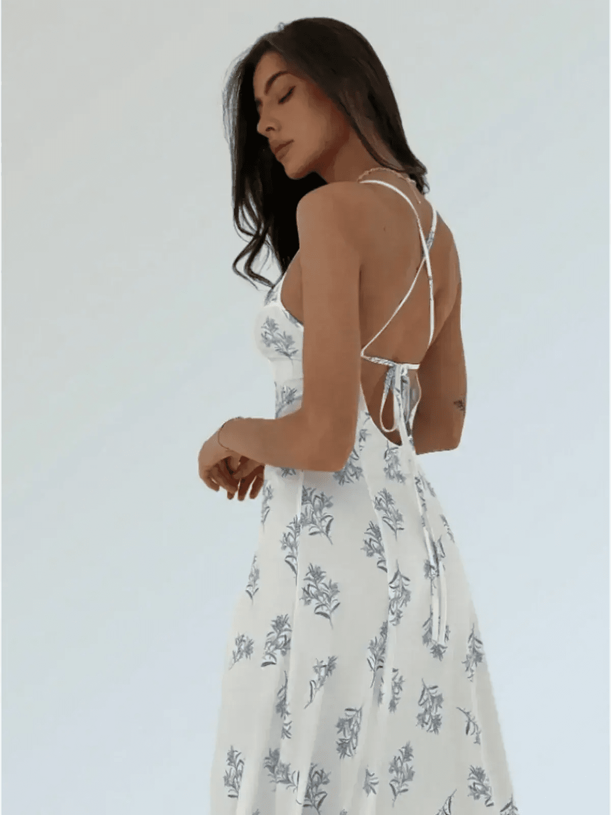 Model showcasing the back of the floral Maxi Dress Bluebelle, featuring a strappy open-back design.