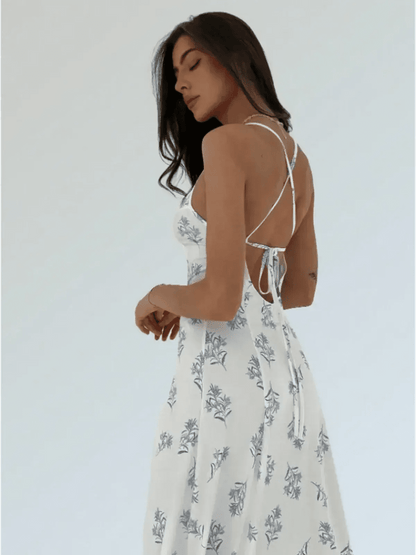 Model showcasing the back of the floral Maxi Dress Bluebelle, featuring a strappy open-back design.