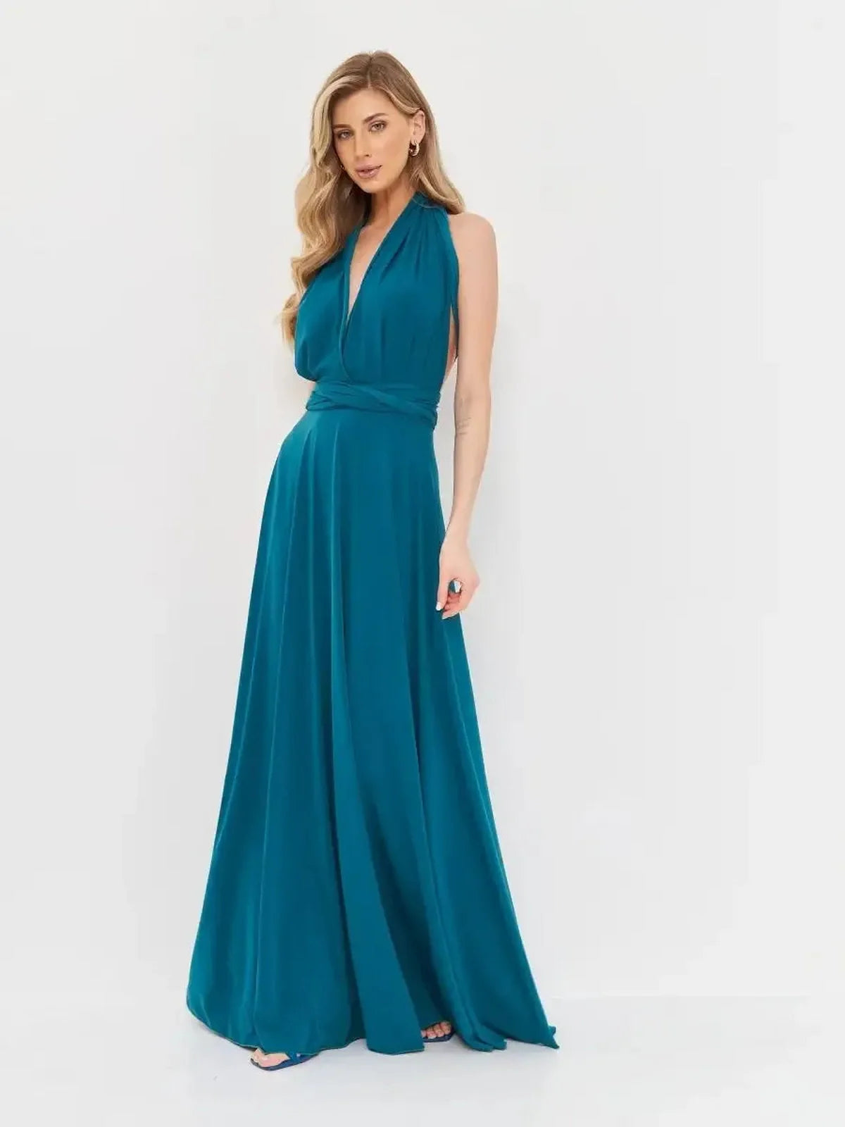 Elegant deep teal maxi dress with draped halter neckline and flowing skirt, perfect for special occasions.