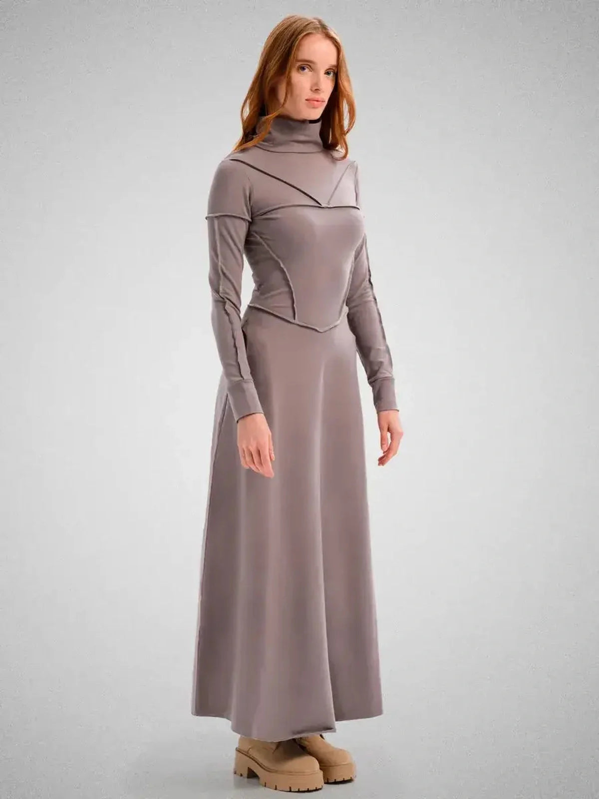 Graceful maxi dress with sculpted fit, funnel neck, and flowing silhouette, perfect for weddings or formal occasions.
