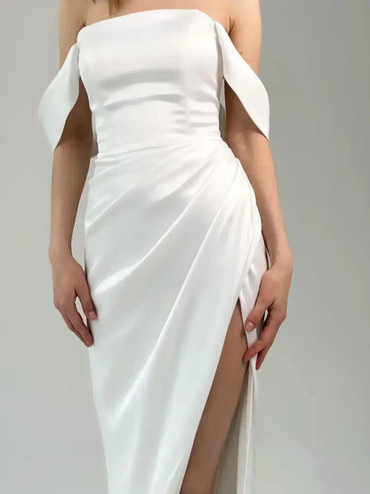 Elegant off-shoulder maxi dress with draped satin fabric and thigh-high slit, perfect for formal occasions.