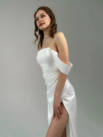 Elegant off-shoulder satin maxi dress with thigh-high slit, embodying sophistication and romance for formal occasions.
