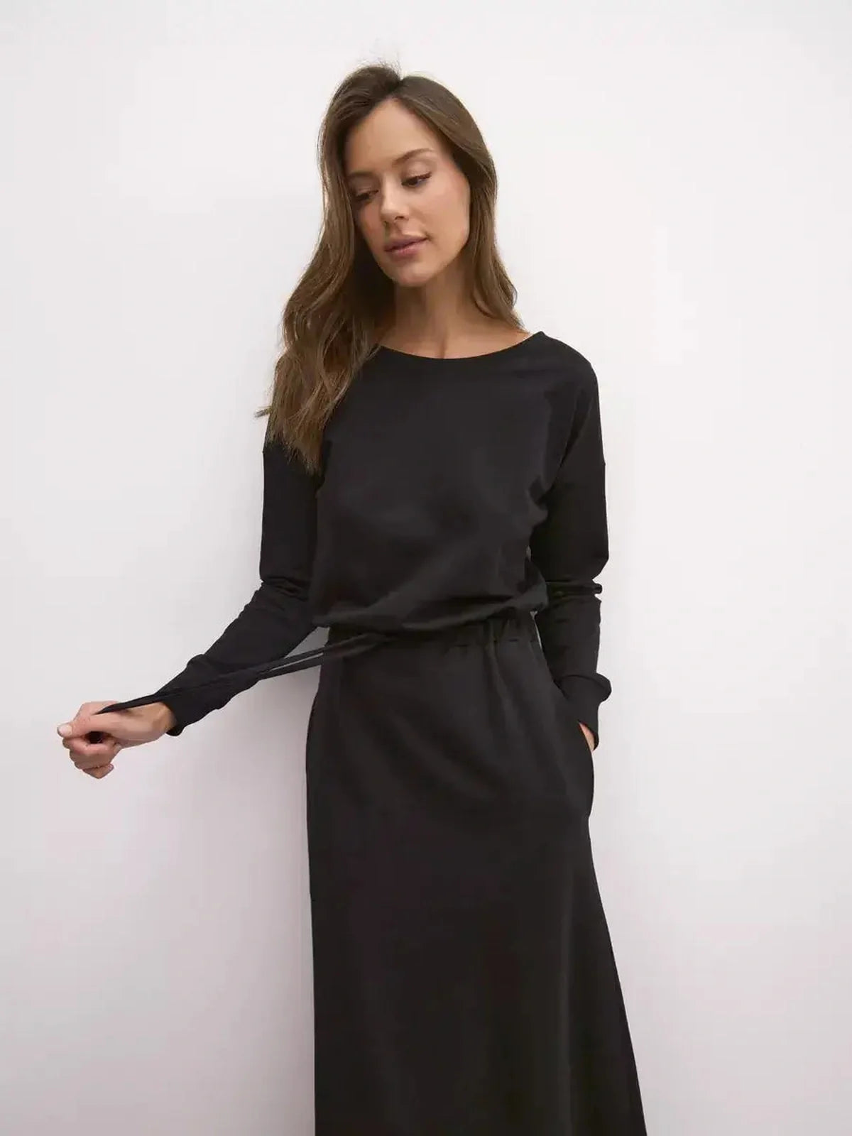 Black maxi dress with long sleeves and cinched waist, perfect for weddings and summer events.