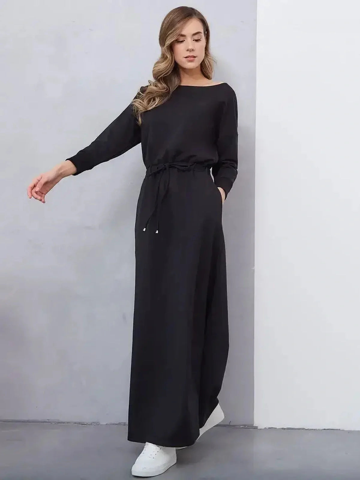 Black maxi dress with cinched waist, long sleeves and boat neckline, perfect for summer, weddings, and casual outings.