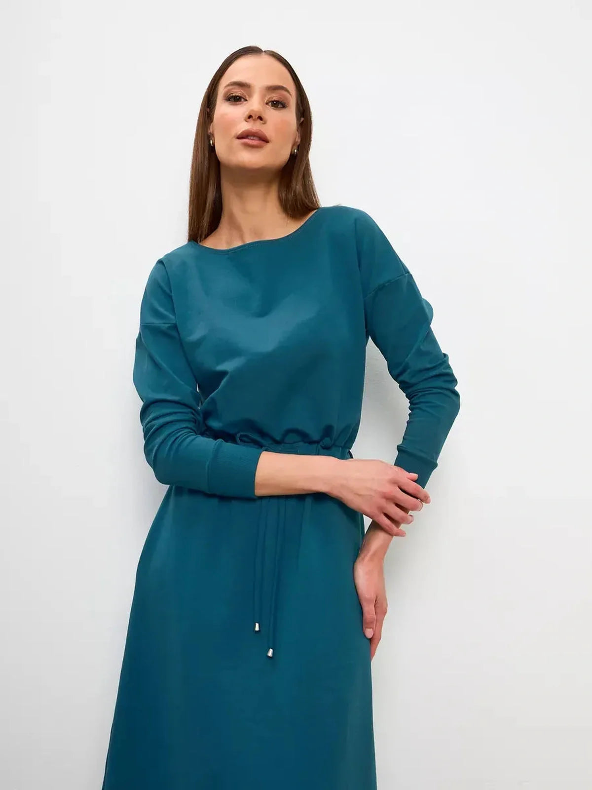 Model showcasing the elegant Maxi Dress Evergreen Ease in forest green with cinched waist and structured neckline.