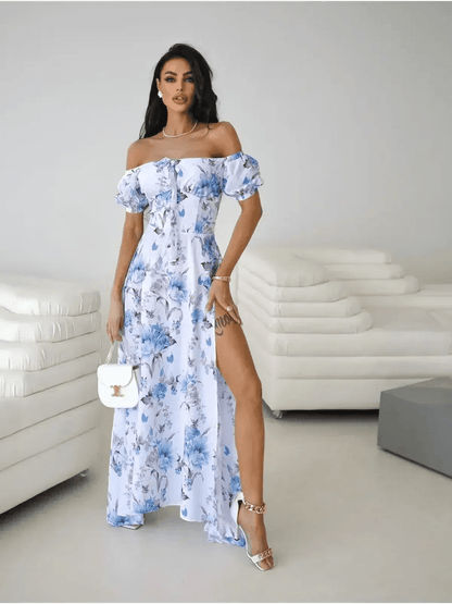 Model wearing off-shoulder floral maxi dress with a thigh-high slit, showcasing elegant femininity and style.