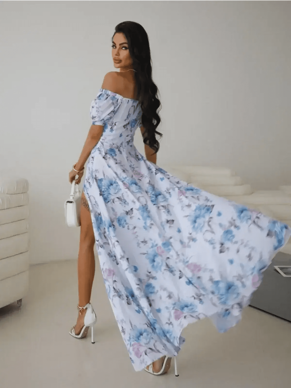 Model showcasing the off-shoulder Maxi Dress Fleurienne with floral print and thigh-high slit, perfect for elegant occasions.
