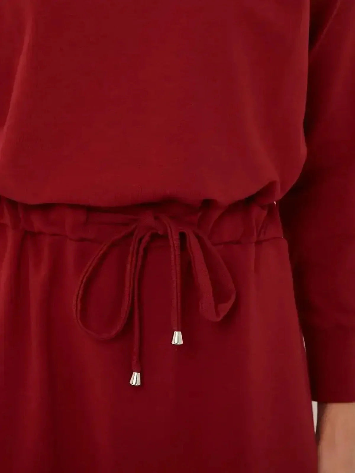 Close-up of the drawstring waist detail on a refined red maxi dress for women, perfect for elegant occasions.