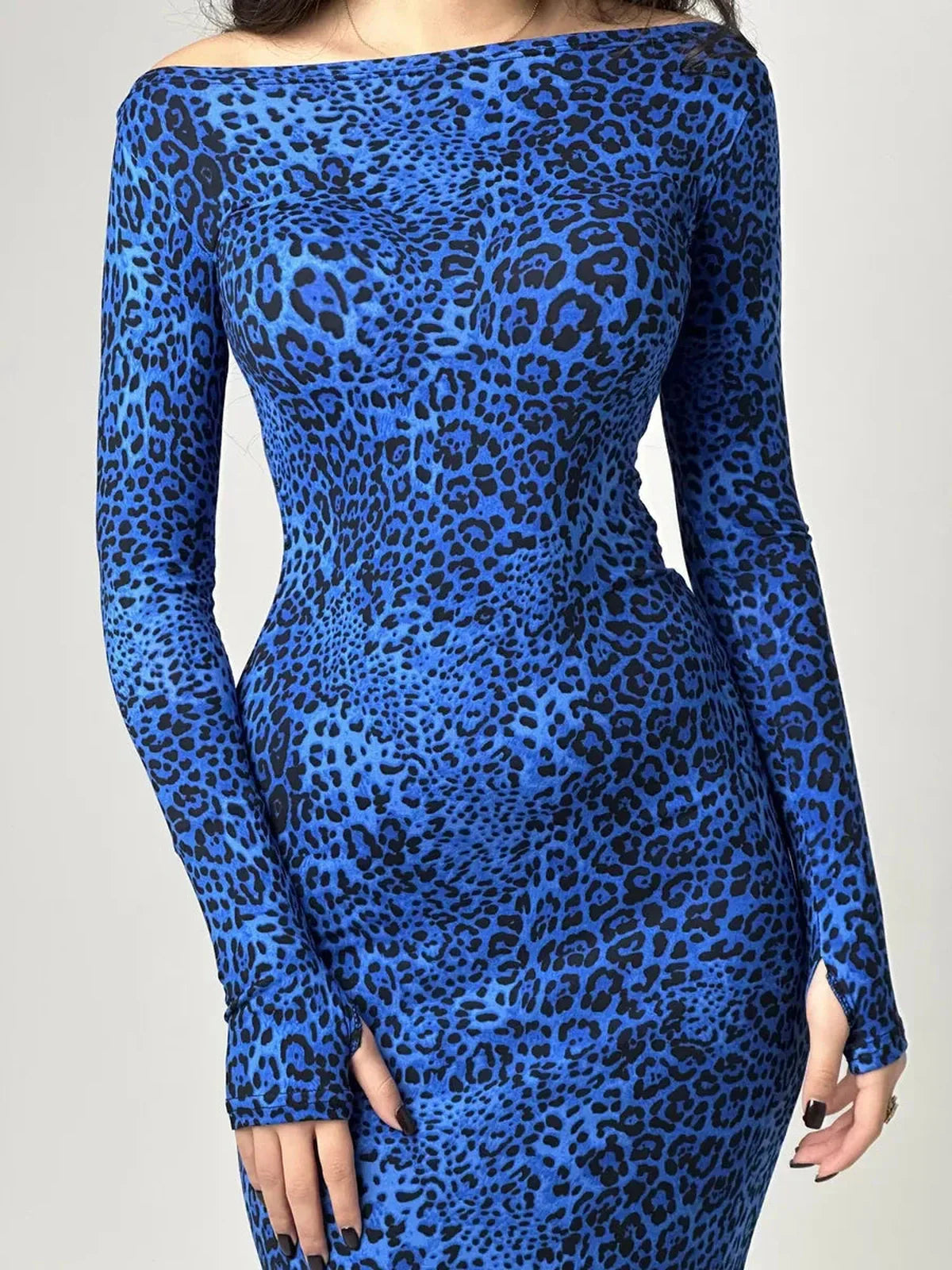 Maxi Dress Midnight Pulse with bold cobalt blue leopard print, showcasing a sleek long sleeve silhouette.