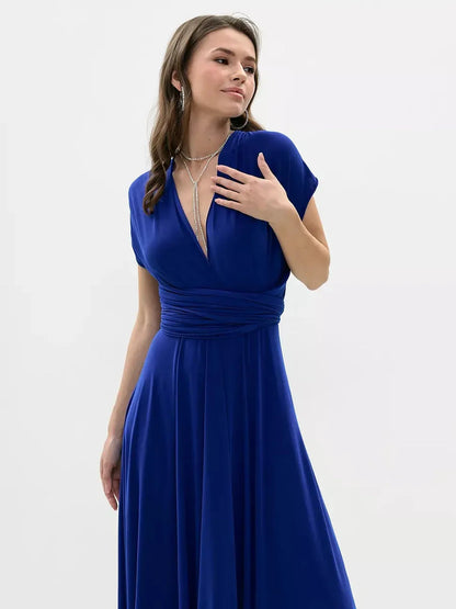 Maxi Dress Sapphire Twist in vibrant blue with a twisted back design, perfect for elegant formal occasions.