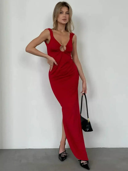 Model wearing a striking red maxi dress with gold ring details, showcasing a sculpting fit and plunge neckline.
