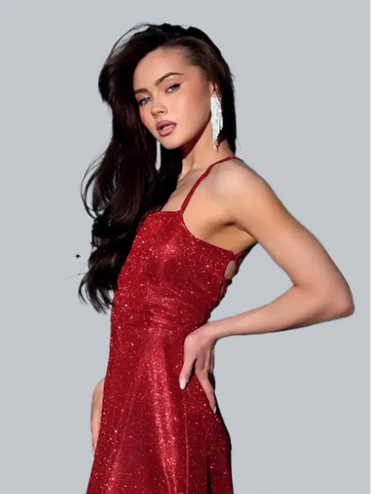 Model in a red shimmer maxi dress with a strappy open back, showcasing an elegant silhouette and sparkling fabric.