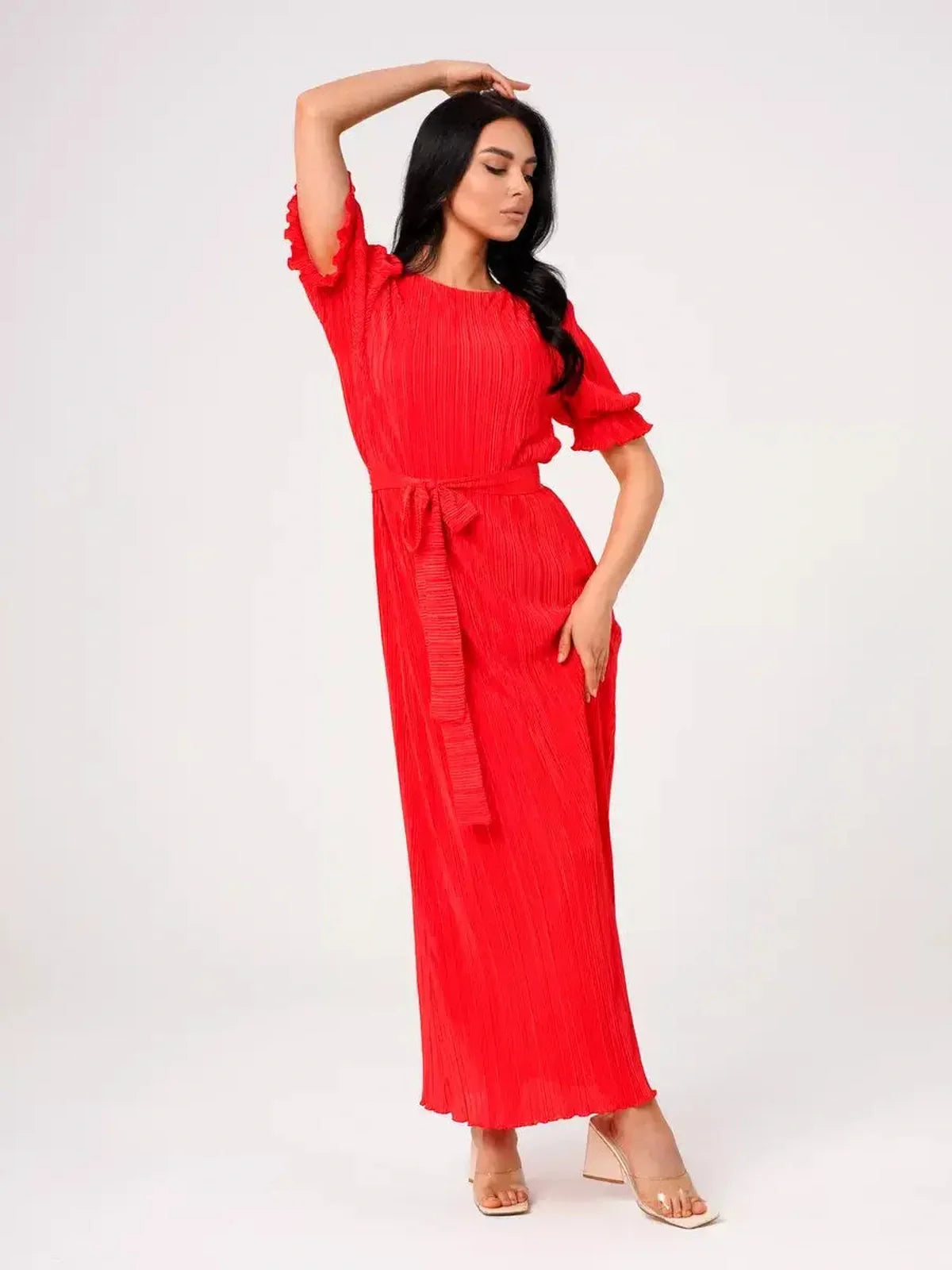 Model wearing a vibrant red pleated maxi dress with a belted waist and puff sleeves, perfect for summer events.