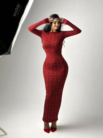 Model showcasing the Wild Inferno Maxi Dress in red leopard print, featuring a curve-hugging silhouette and long sleeves.