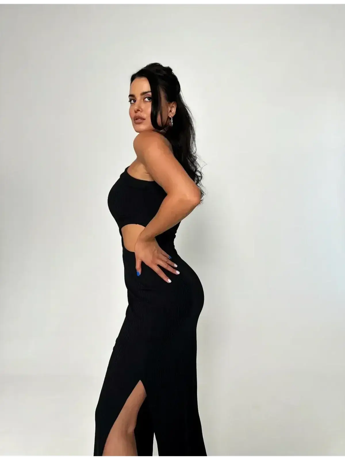 Model showcasing the Midnight Allure Midi Dress with a sultry side slit and cutout waist, exuding elegance and confidence.