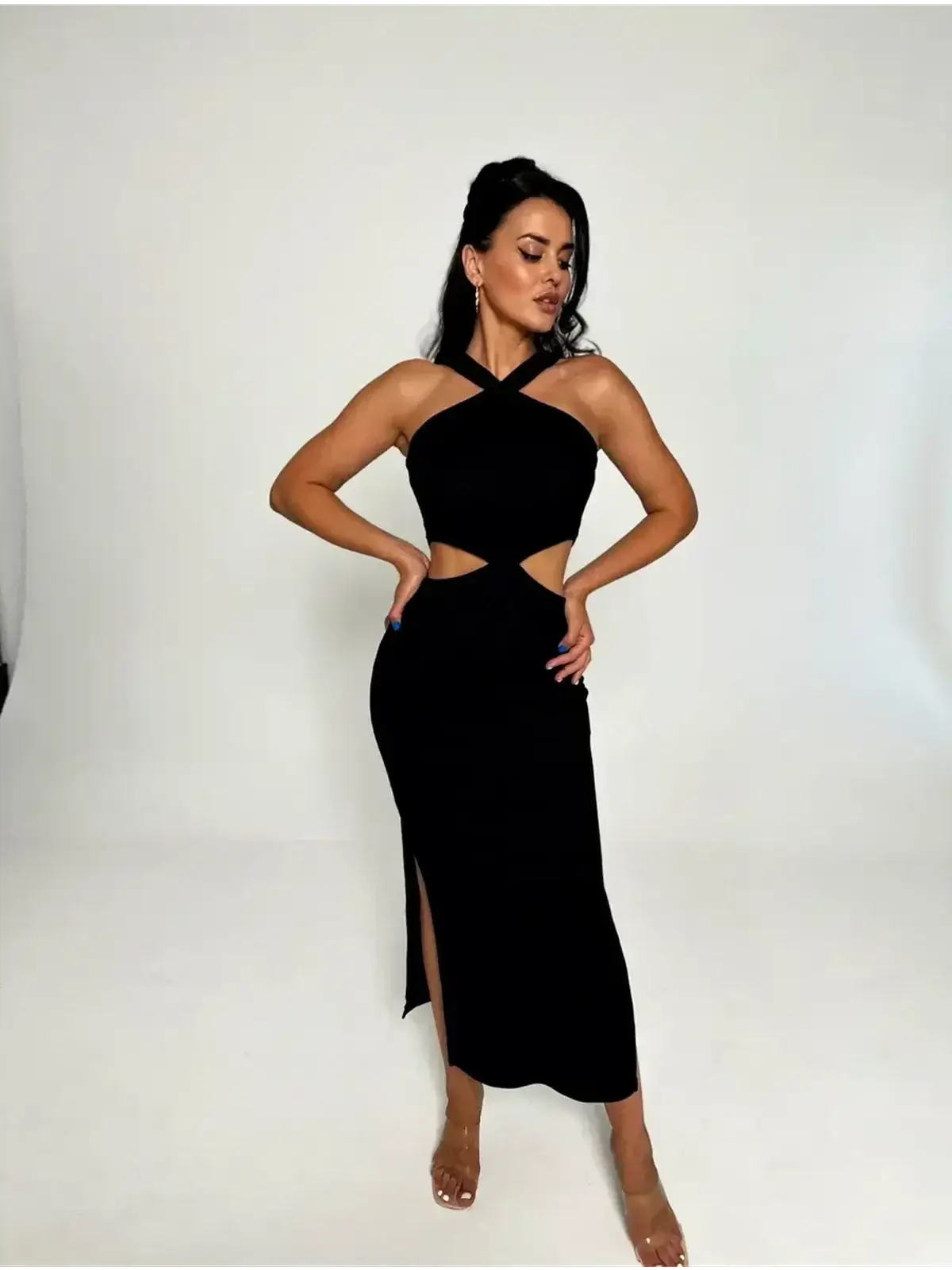 Model posing in Midnight Allure Midi Dress, showcasing cutout waist, cross-strap neckline, and sultry side slit.