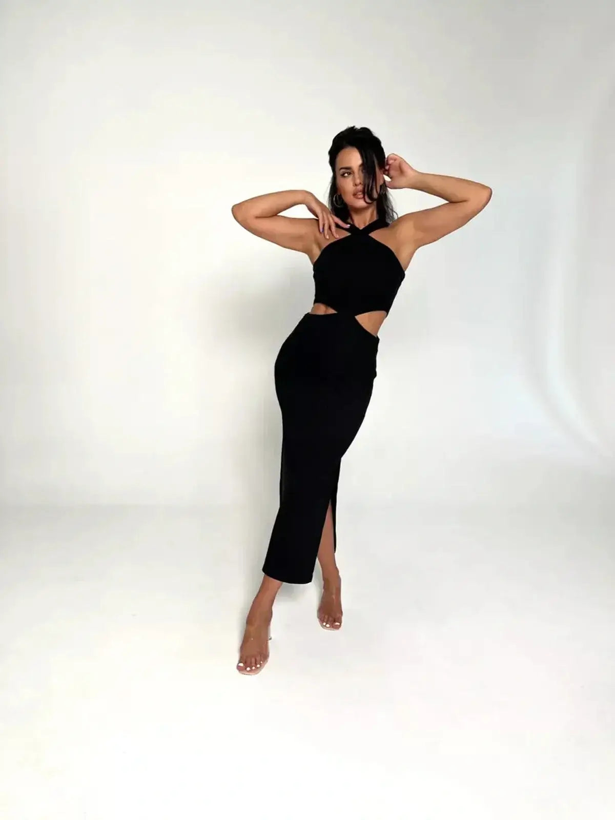 Model wearing the Midnight Allure Midi Dress featuring a cutout waist and sultry side slit on a minimalist background.