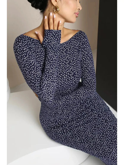 Midnight Curve Maxi Dress in dark navy featuring long sleeves and a sculpted fit, showcasing an elegant silhouette.