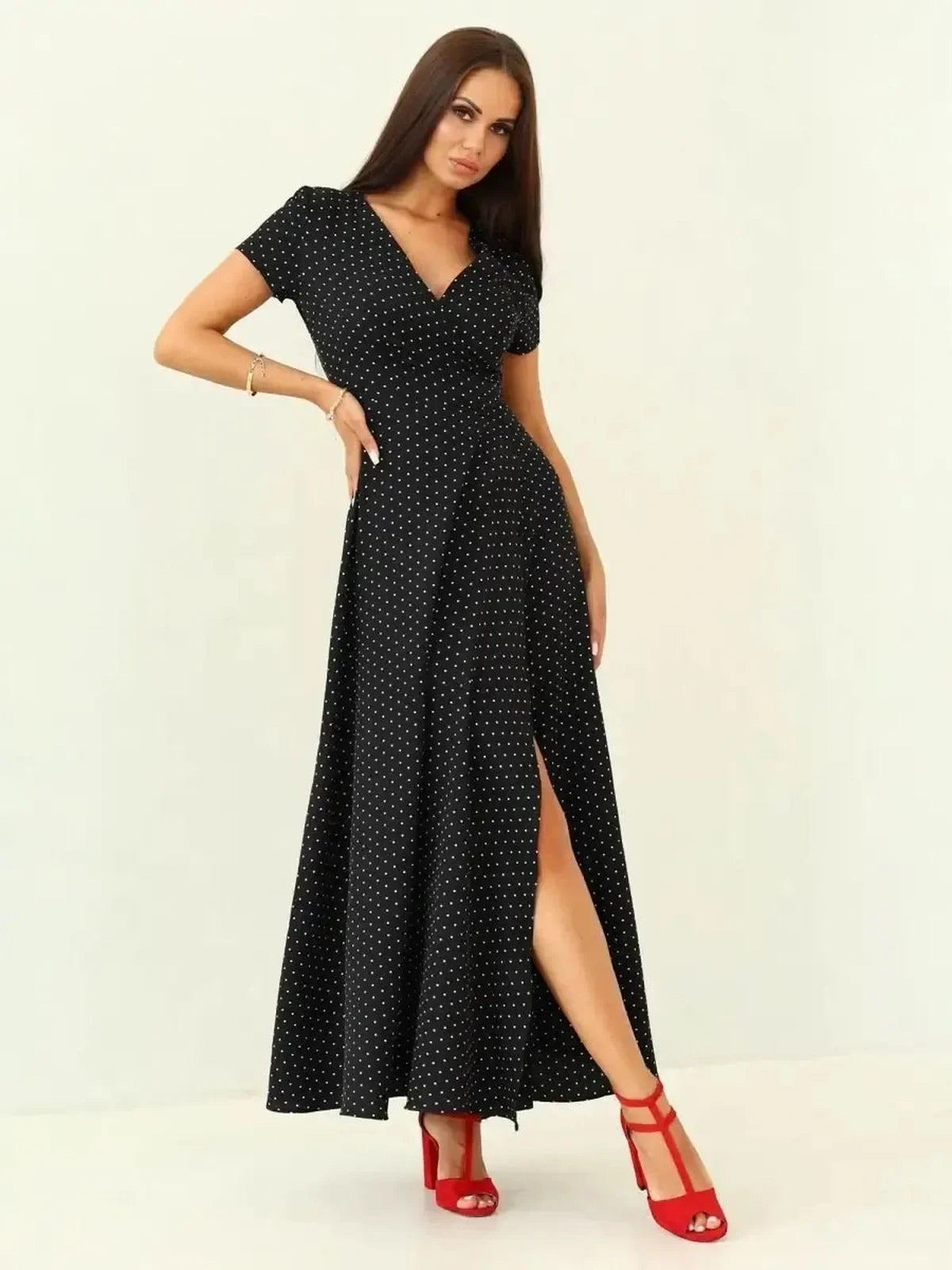 Elegant Midnight Dots Maxi Dress in black with white polka dots, featuring a wrap bodice and thigh-high slit.