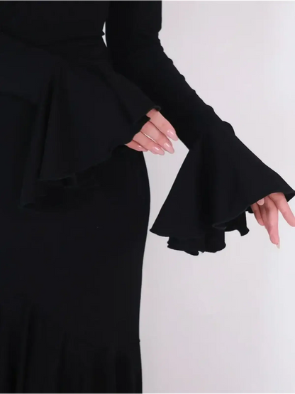 Close-up of Mirage Maxi Dress featuring elegant flared cuffs and a fitted silhouette in black fabric.