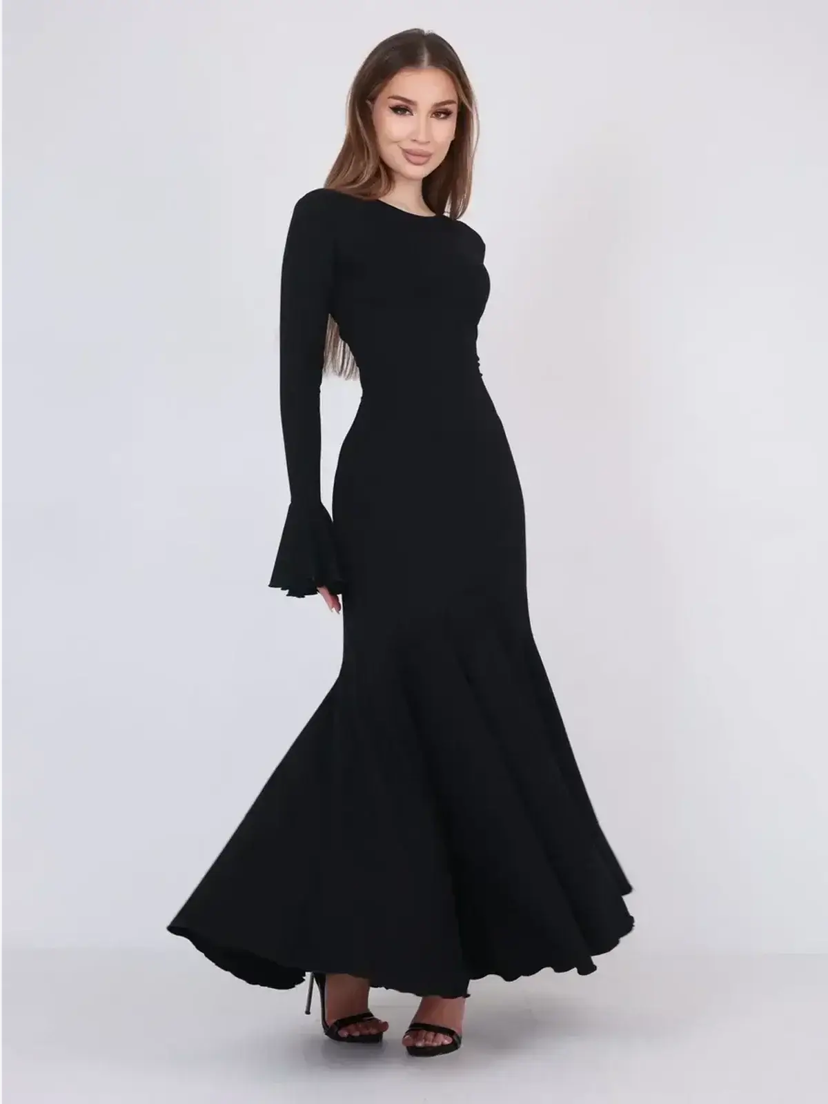 Mirage Maxi Dress in black, featuring flared cuffs and a fishtail hem for an elegant evening or formal look.
