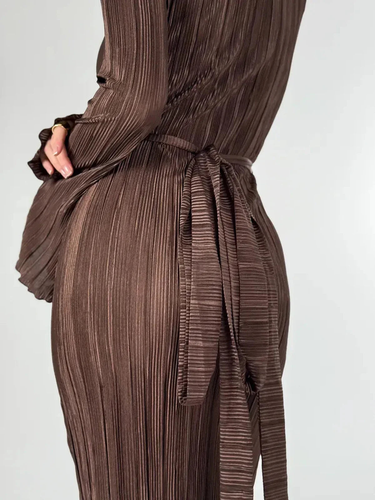 Detail of Mocha Drape Maxi Dress showcasing sculpted pleats and matching belt emphasizing the waist in rich chocolate hue.