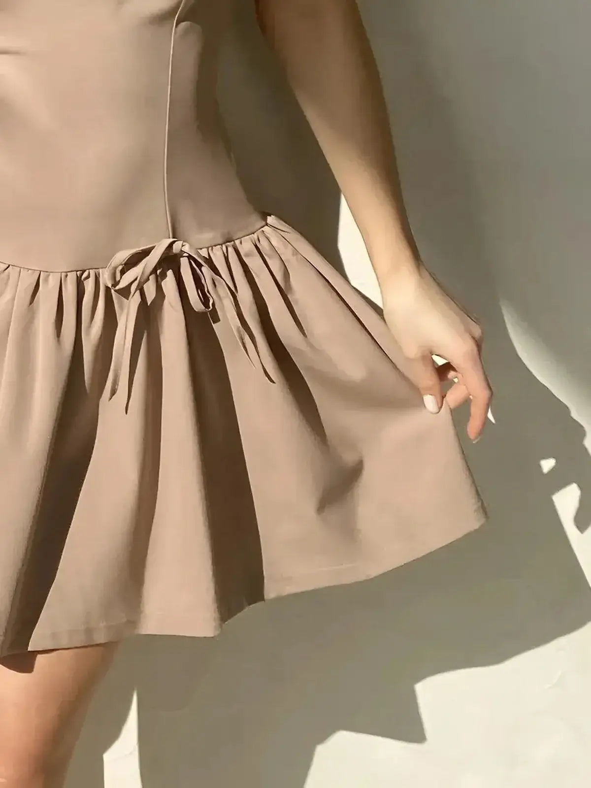 Mocha flare mini dress featuring a structured bodice and gathered flared hem, ideal for summer weddings and parties.