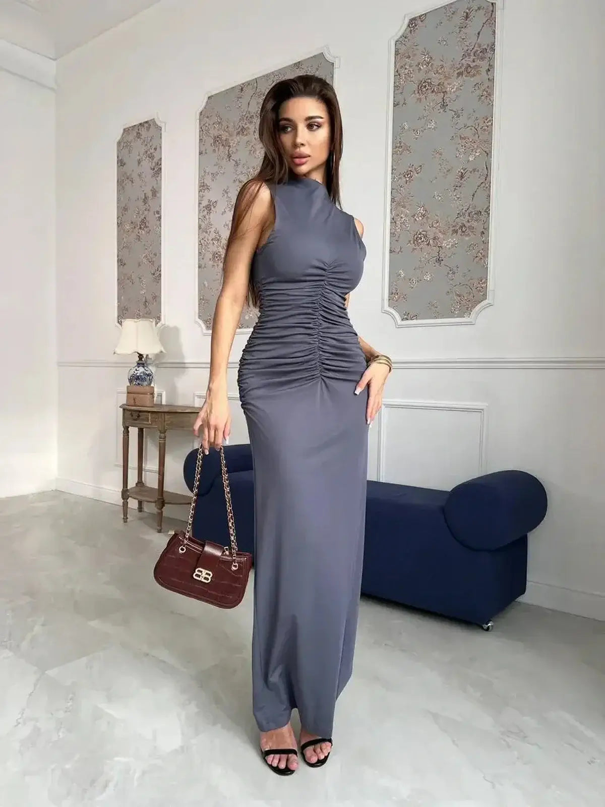 Model wearing the Moonveil Maxi Dress in graphite-gray with ruching and a high neckline, styled for elegance.