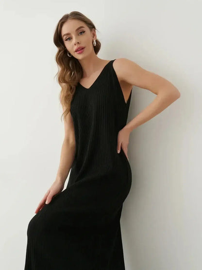 Muse Knit Maxi Dress in black, featuring a modern V-neckline and ribbed knit fabric, showcasing an elegant silhouette.