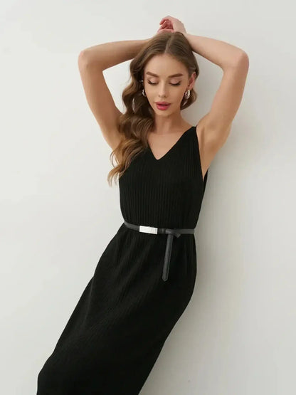 Model wearing a black Muse Knit Maxi Dress, showcasing its elegant V-neckline and sleek silhouette.