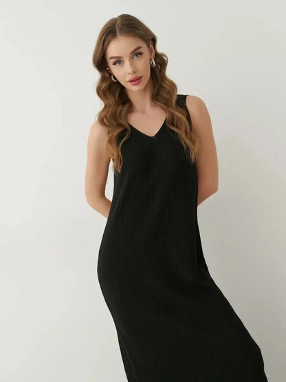 Model wearing the Muse Knit Maxi Dress in black, showcasing its sleek design and elegant V-neckline.