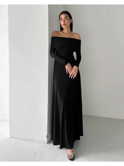 Off-shoulder Muse Maxi Dress in black, featuring a sleek fit and full-length skirt, perfect for elegant evening events.