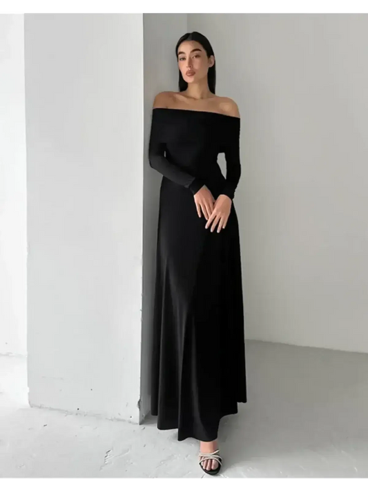 Off-shoulder Muse Maxi Dress in black, featuring a sleek fit and full-length skirt, perfect for elegant evening events.