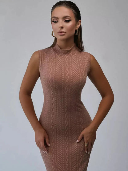 Model wearing a cocoa-toned Museline Maxi Dress in luxe jacquard knit with intricate cable patterns and a modern stand collar.