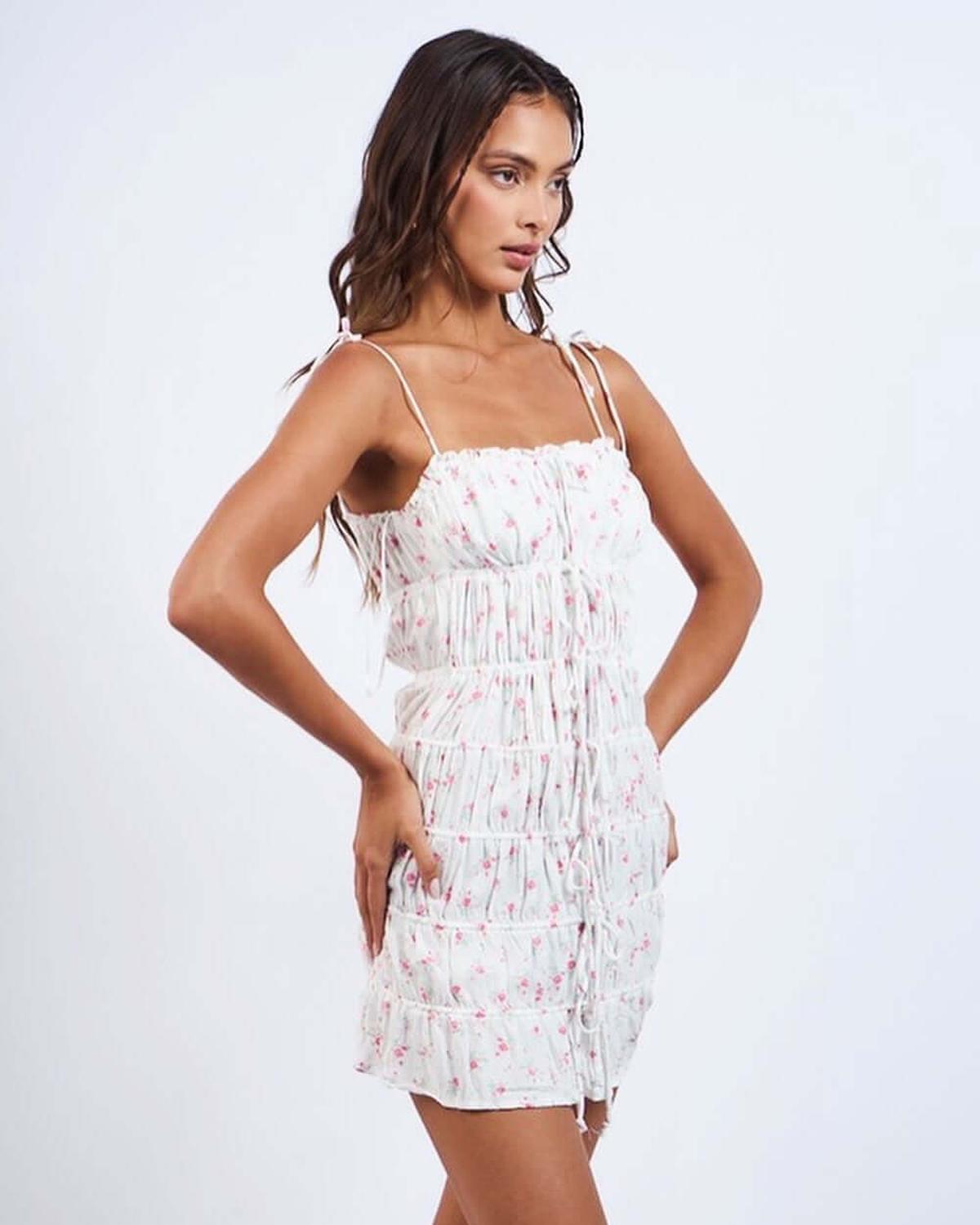 Nina Mini Dress featuring floral design and ruched detailing, perfect for summer weddings and cocktail parties.