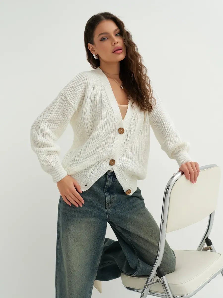 Noelle Cardigan by Lauven, an elegant white knitwear piece with button detailing, perfect for layering.