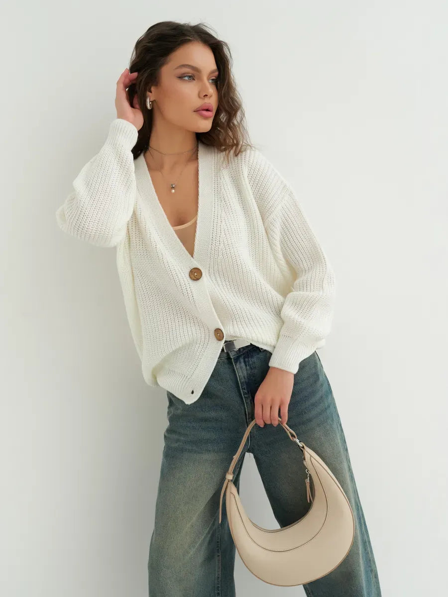 Model wearing the Noelle Cardigan by Lauven, an elegant white knitwear piece with button detailing.