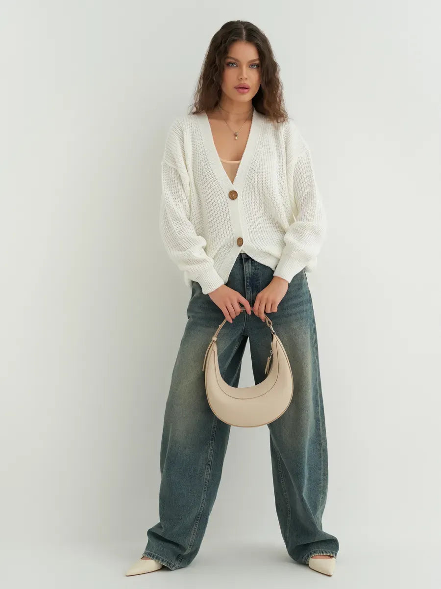 Noelle Cardigan by Lauven, elegant white knitwear with button detailing styled with denim and a handbag.