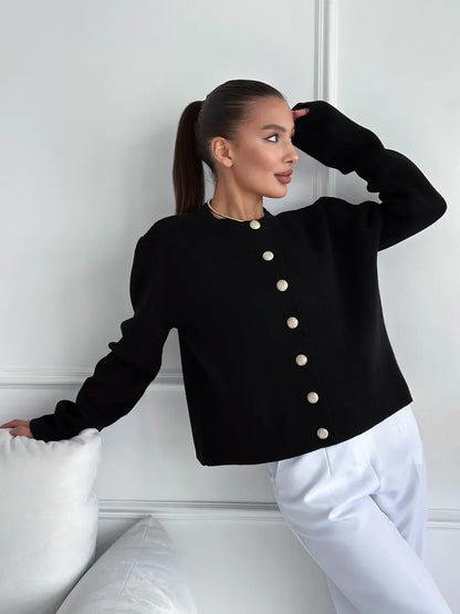 Model wearing Noir Cardigan by Lauven, an elegant cropped black knitwear piece with buttons.
