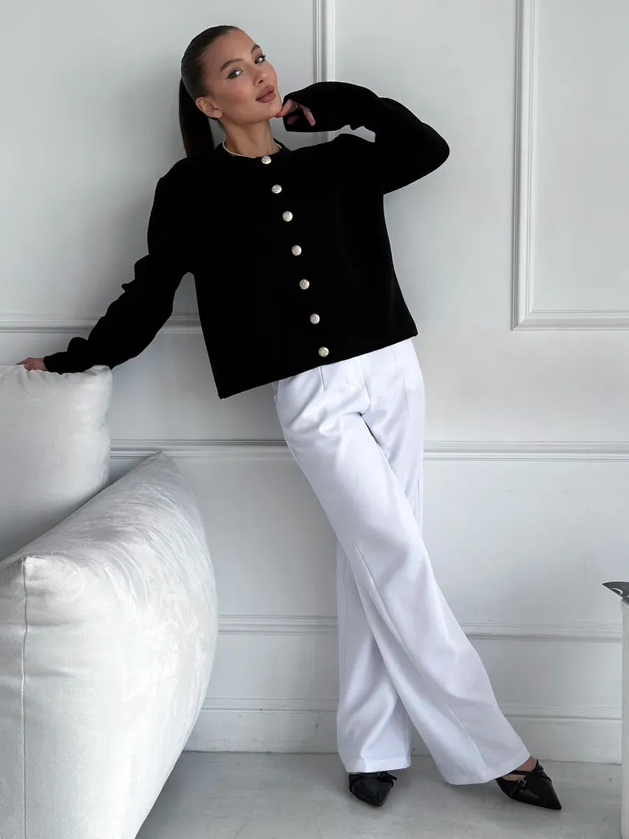 Noir Cardigan by Lauven, elegant cropped knitwear in black, styled with white pants for a chic look.
