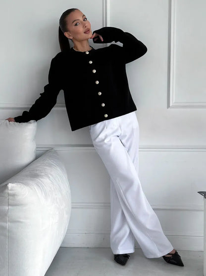 Noir Cardigan by Lauven, elegant cropped knitwear in black, styled with white pants for a chic look.