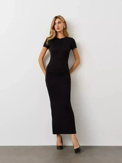 Model wearing the Noir Curve Maxi Dress by Lauven, featuring a sculpted silhouette in iconic black.