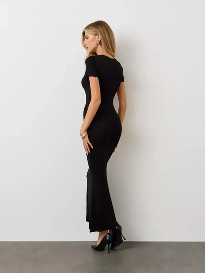 Noir Curve Maxi Dress by Lauven – Side view showcasing its sculpted silhouette and flared maxi hem.