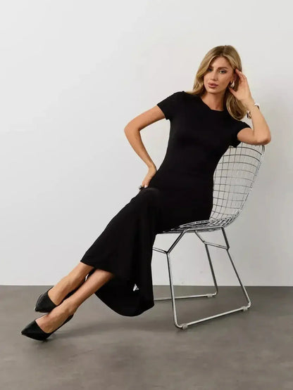 Model wearing the Noir Curve Maxi Dress by Lauven, showcasing a sculpted silhouette in iconic black.