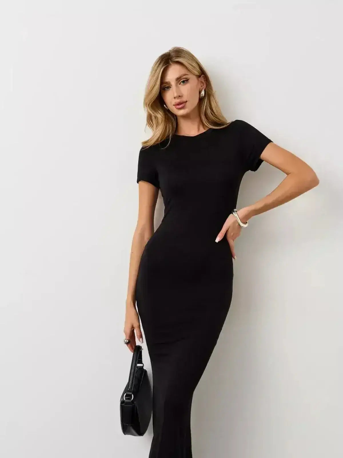 Lauven Noir Curve Maxi Dress showcasing a sculpted silhouette in iconic black, perfect for day to night transitions.