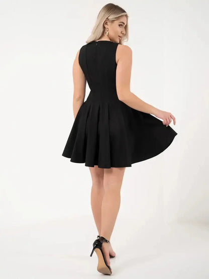 A stylish woman in a flared black dress showcasing a playful yet chic silhouette.