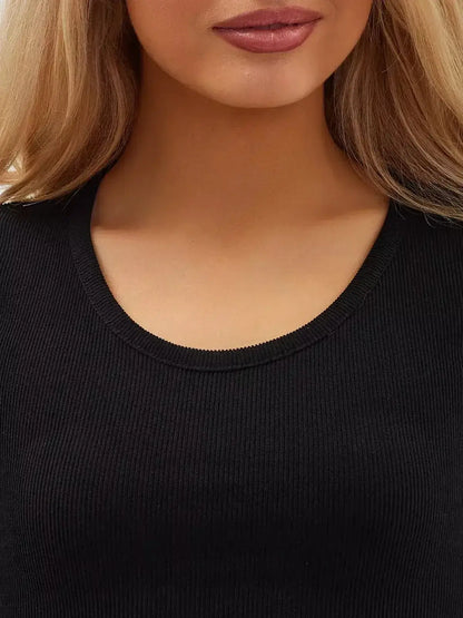 Close-up of a woman's neckline in a black ribbed fabric, showcasing elegance and style in women's clothing.